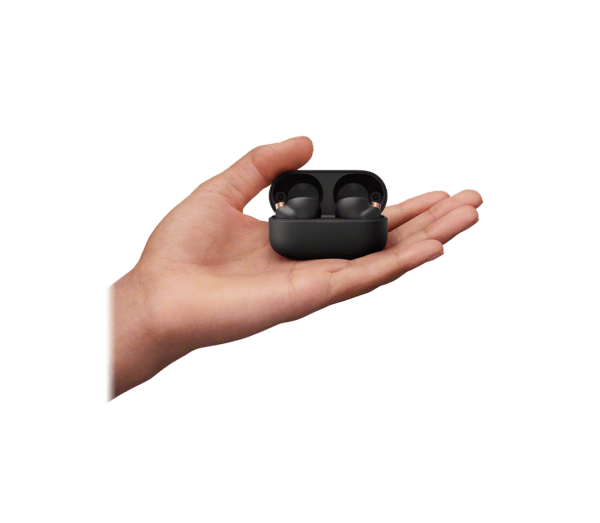 Person's hand holding a black wireless earbud from the WF-1000XM4 model by Sony